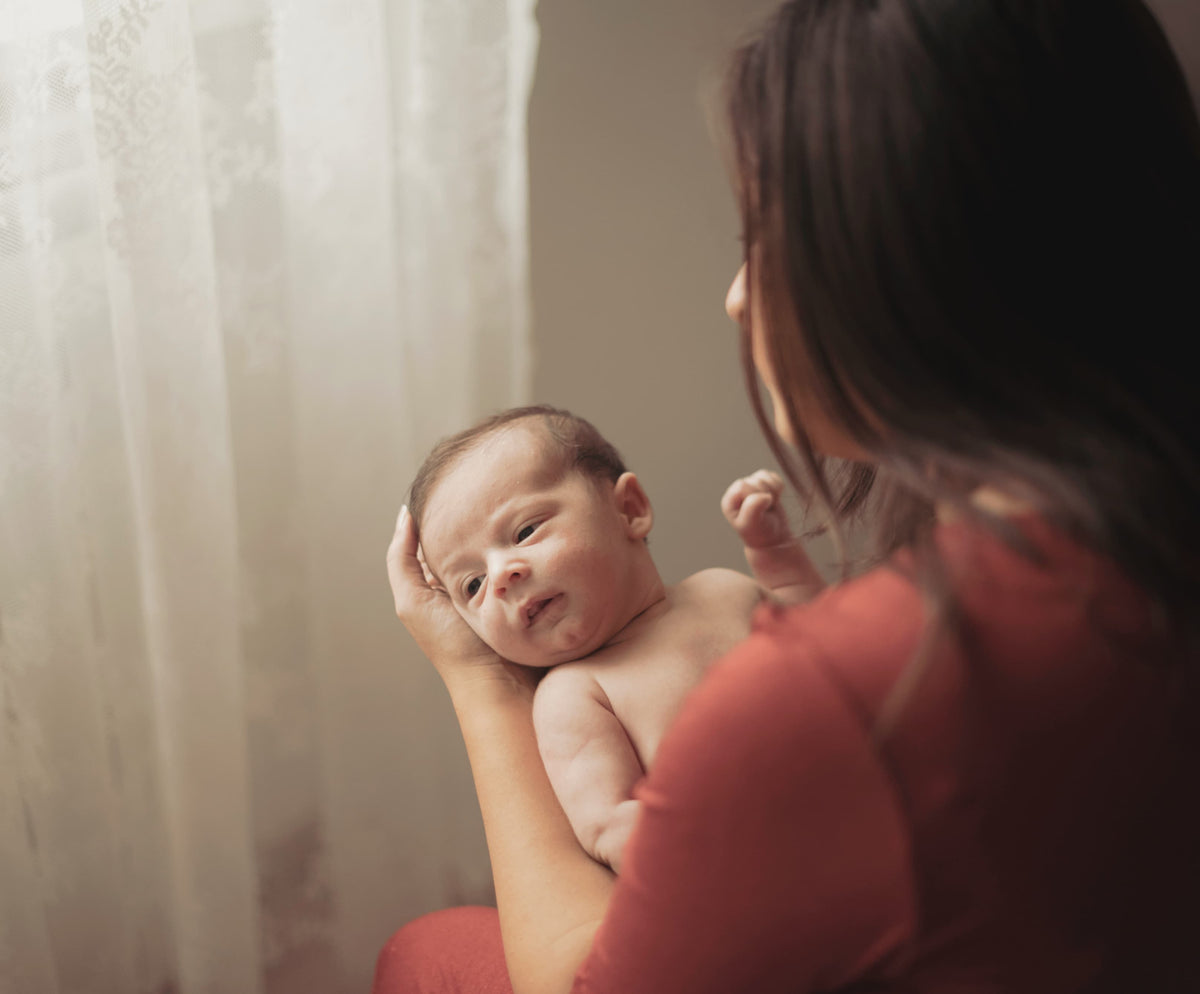 mother-holding-adorable-little-baby