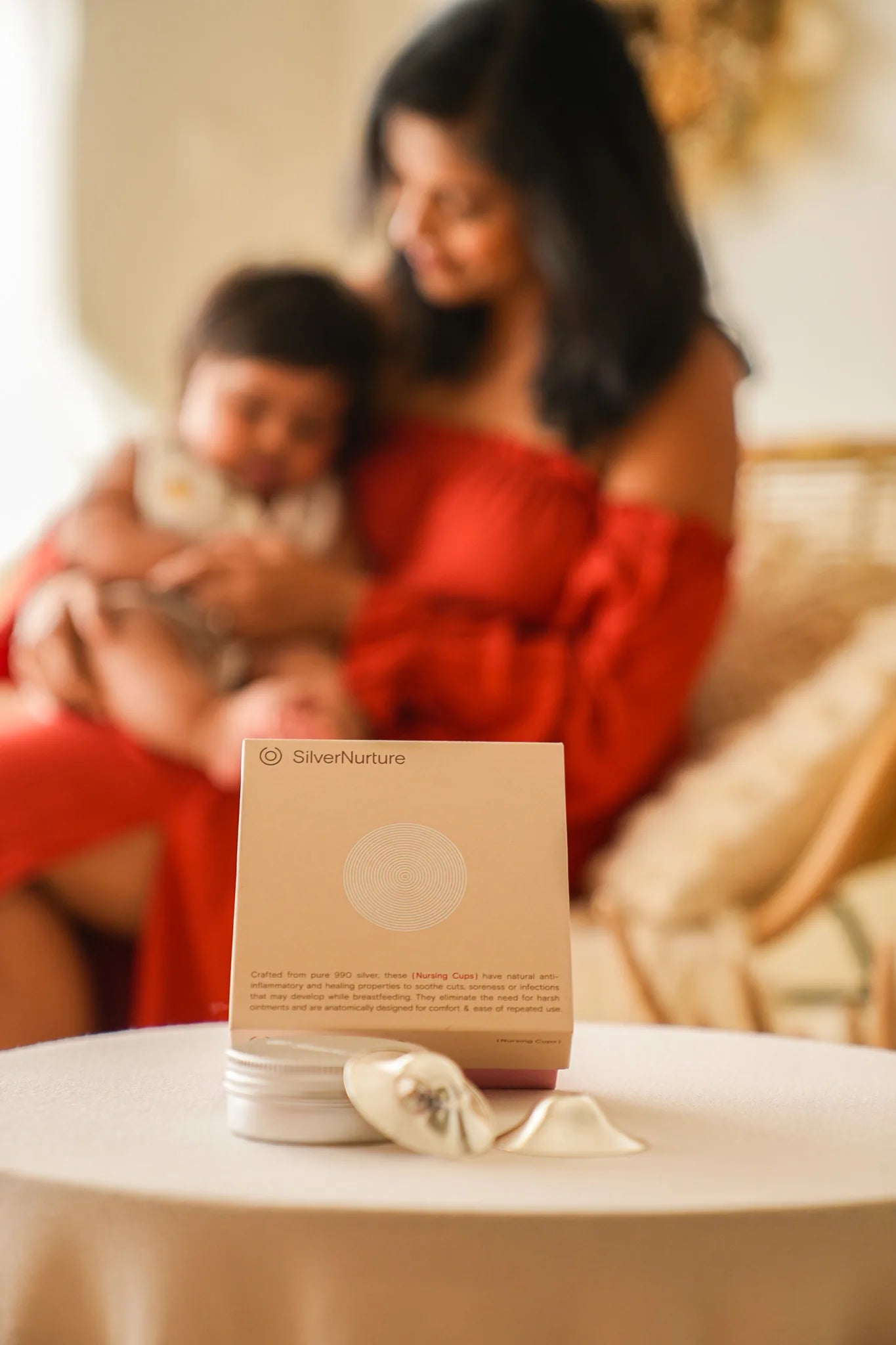 Silver Nurture nursing cups with a mother and baby